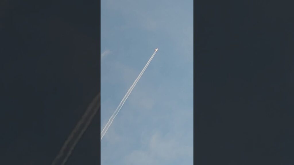 Contrail from an aeroplane – view from National Stadium